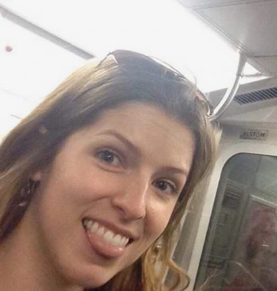 Anna Kendrick having fun inside the subway train