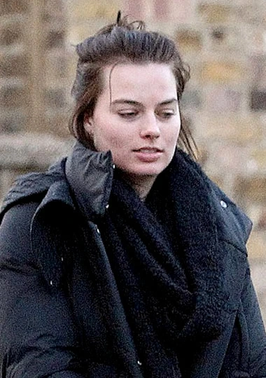Margot Robbie with messy hair bun on the street